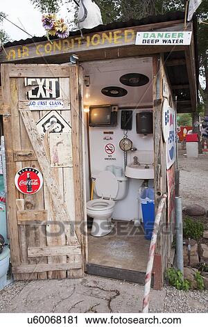 Stock Image - Outhouse with humorous signs, Route 66, Seligman, Arizona. Fotosearch