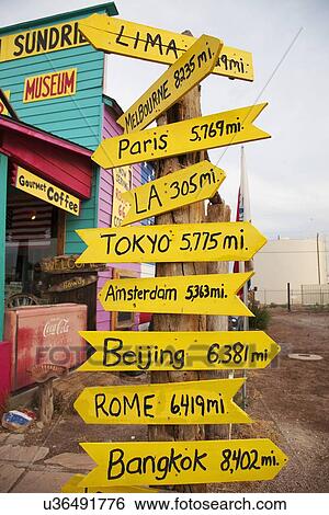 Stock Photograph - Road signs to Paris, Rome, Bangkok, Los Angeles, Lima, Seligman, Arizona. Fotosearch