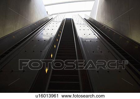 Stock Image - Stairway to heaven in Washington D. C. Metrorail escalator to mass transet trains. Fotosearch