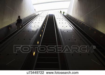 Stock Image - Stairway to heaven in Washington D. C. Metrorail escalator to mass transet trains. Fotosearch
