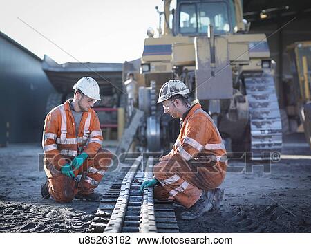 Apprentice and engineer work on machinery in surface coal mine View Large Photo Image Stock Image - Apprentice and engineer work on machinery in surface coal mine. Fotosearch