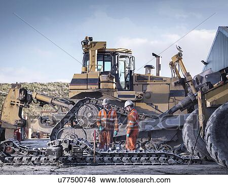 Apprentice and engineer work on machinery in surface coal mine View Large Photo Image Stock Photo - Apprentice and engineer work on machinery in surface coal mine. Fotosearch