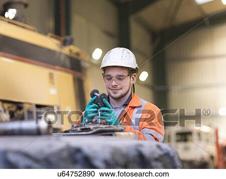 Apprentice engineer inspecting equipment in surface coal mine View Large Photo Image Stock Image - Apprentice engineer inspecting equipment in surface coal mine. Fotosearch