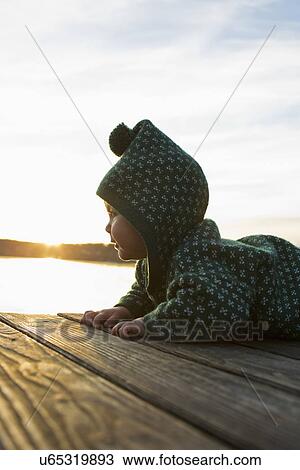 Baby girl crawling on jetty View Large Photo Image Stock Image - Baby girl crawling on jetty. Fotosearch