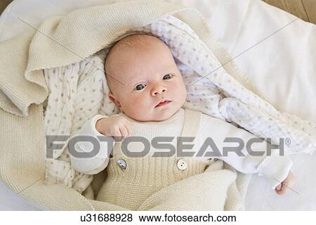 Baby girl lying on bedclothes View Large Photo Image Stock Photo - Baby girl lying on bedclothes. Fotosearch