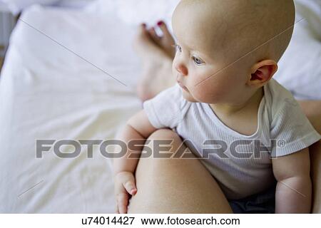 Baby girl on mother's lap View Large Photo Image Stock Photo - Baby girl on mother's lap. Fotosearch