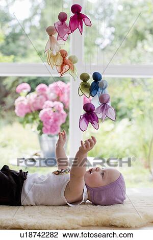 Baby girl playing with mobile View Large Photo Image Stock Image - Baby girl playing with mobile. Fotosearch