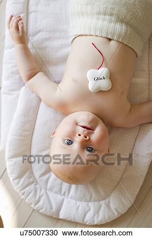 Baby girl with lucky charm View Large Photo Image Stock Image - Baby girl with lucky charm. Fotosearch