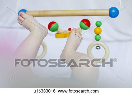 Baby girl's feet playing with mobile View Large Photo Image Stock Photograph - Baby girl's feet playing with mobile. Fotosearch