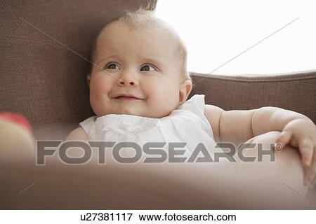Baby sitting in armchair View Large Photo Image Stock Photo - Baby sitting in armchair. Fotosearch