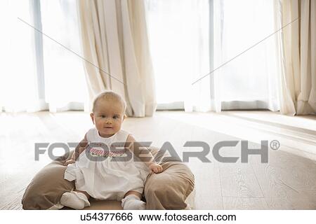 Baby sitting on floor View Large Photo Image Stock Photograph - Baby sitting on floor. Fotosearch