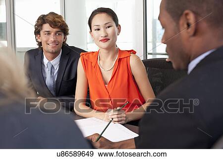 Business colleagues holding meeting in office View Large Photo Image Stock Photo - Business colleagues holding meeting in office. Fotosearch