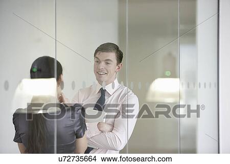 Business colleagues in discussion through glass View Large Photo Image Picture - Business colleagues in discussion through glass. Fotosearch
