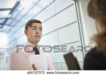 Stock Image - Business colleagues in discussion. Fotosearch