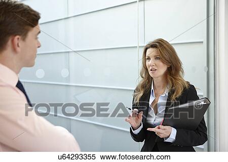 Stock Photography - Business colleagues in discussion. Fotosearch