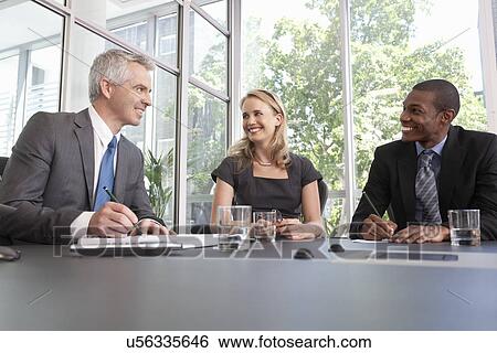 Business manager and team holding meeting in office View Large Photo Image Stock Photograph - Business manager and team holding meeting in office. Fotosearch