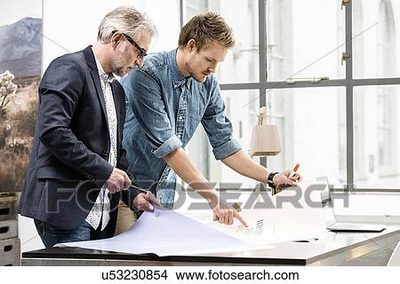 Business men in discussion at office View Large Photo Image Picture - Business men in discussion at office. Fotosearch