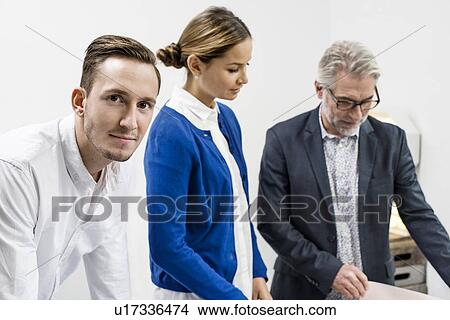 Picture - Business people in discussion at office. Fotosearch
