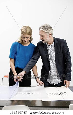 Stock Image - Business people in discussion at office. Fotosearch