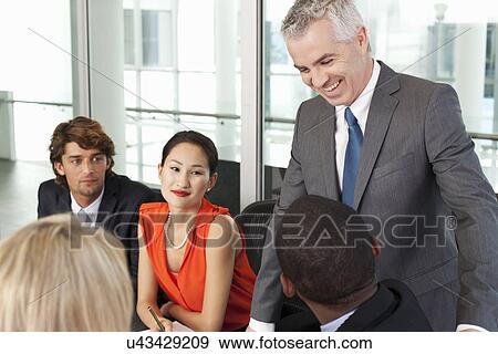 Business team holding meeting in office View Large Photo Image Stock Photo - Business team holding meeting in office. Fotosearch