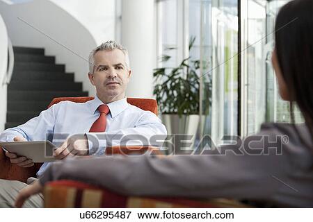 Stock Photo - Businessman holding interview in office. Fotosearch