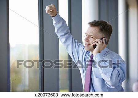 Stock Image - Businessman on cell phone. Fotosearch