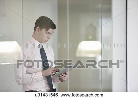 Businessman suing digital tablet View Large Photo Image Stock Photograph - Businessman suing digital tablet. Fotosearch