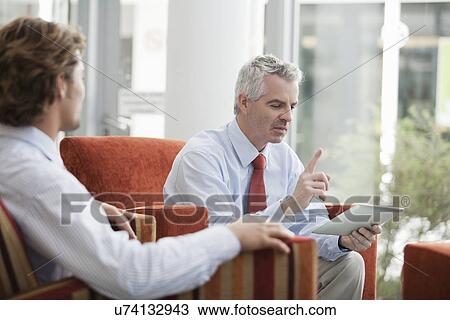 Businessmen brainstorming in office View Large Photo Image Stock Image - Businessmen brainstorming in office. Fotosearch