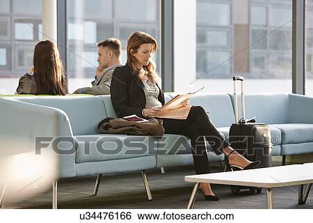 Stock Photograph - Businesswoman in departure lounge. Fotosearch
