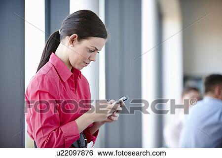 Stock Photograph - Businesswoman using cell phone. Fotosearch