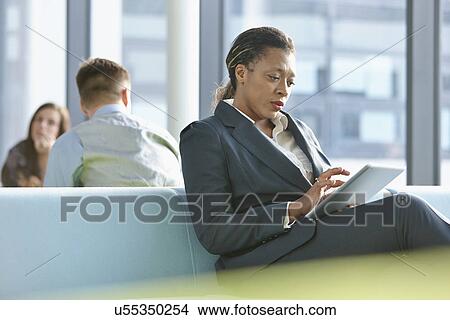 Businesswoman using digital tablet View Large Photo Image Picture - Businesswoman using digital tablet. Fotosearch