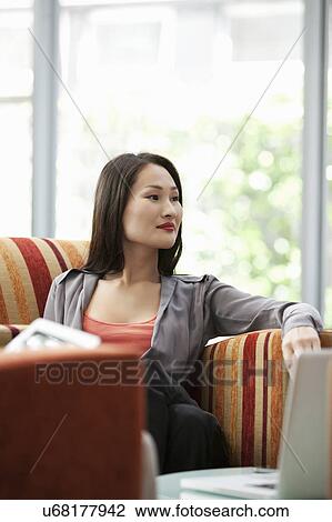 Businesswoman waiting for meeting in office View Large Photo Image Stock Image - Businesswoman waiting for meeting in office. Fotosearch