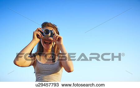 Candid portrait of girl looking through camera View Large Photo Image Stock Image - Candid portrait of girl looking through camera. Fotosearch