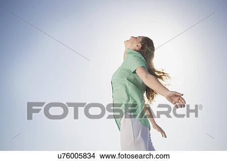 Picture - Carefree mid adult woman with head back and eyes closed. Fotosearch