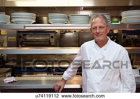 Stock Image - Chef in kitchen. Fotosearch