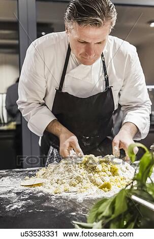 Chef mixing gnocchi dough in commercial kitchen View Large Photo Image Stock Image - Chef mixing gnocchi dough in commercial kitchen. Fotosearch