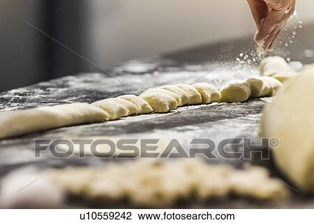 Chef's hand sprinkling flour on gnocchi in commercial kitchen View Large Photo Image Stock Image - Chef's hand sprinkling flour on gnocchi in commercial kitchen. Fotosearch