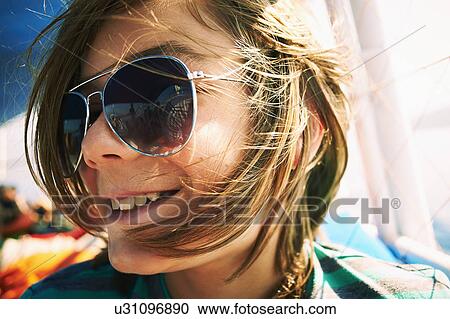 Close up candid portrait of boy in sunglasses View Large Photo Image Stock Image - Close up candid portrait of boy in sunglasses. Fotosearch