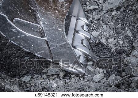 Stock Image - Close up of digger bucket in surface coal mine. Fotosearch