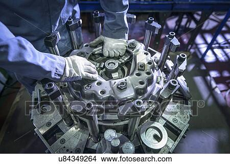 Close up of engineer assembling industrial clutch on production line View Large Photo Image Picture - Close up of engineer assembling industrial clutch on production line. Fotosearch