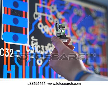 Close up of engineer holding electronic circuitry for automotive use View Large Photo Image Picture - Close up of engineer holding electronic circuitry for automotive use. Fotosearch