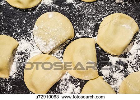 Stock Image - Close up of freshly prepared tortellini. Fotosearch