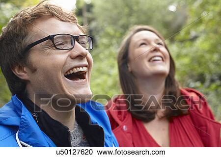 Stock Image - Close up of happy young couple in woods. Fotosearch