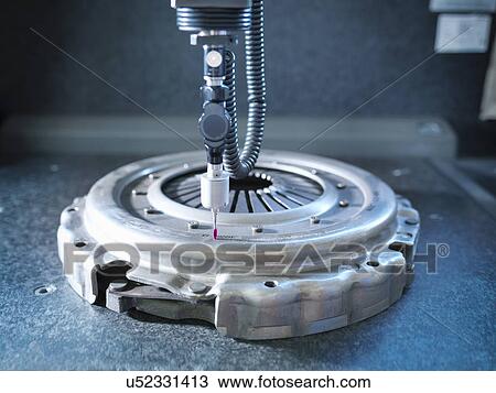 Stock Image - Close up of industrial clutch in factory measuring machine. Fotosearch