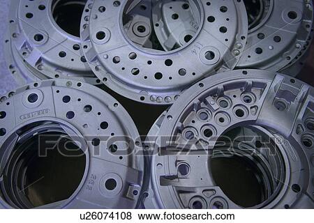 Stock Photo - Close up of industrial clutch parts on production line, overhead view. Fotosearch