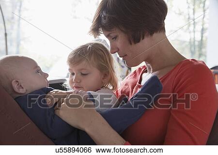 Close up of mother, baby boy and female toddler View Large Photo Image Stock Photograph - Close up of mother, baby boy and female toddler. Fotosearch