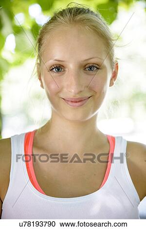 Stock Image - Close up portrait of female basketball player in park. Fotosearch