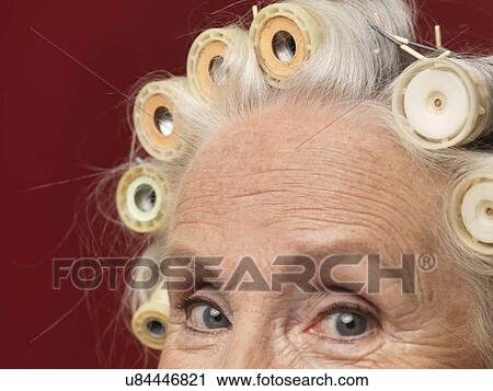 Close up studio portrait of senior woman in hair rollers View Large Photo Image Stock Image - Close up studio portrait of senior woman in hair rollers. Fotosearch