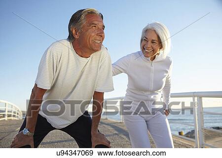 Couple doing squatting exercise View Large Photo Image Stock Photo - Couple doing squatting exercise. Fotosearch