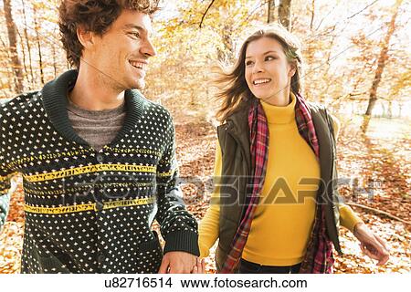 Couple holding hands, smiling View Large Photo Image Picture - Couple holding hands, smiling. Fotosearch